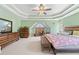 Spacious main bedroom with tray ceilings, carpet, and plenty of natural light at 850 Long Branch Cir, Sugar Hill, GA 30518