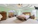 Spacious main bedroom with tray ceilings, carpet, and plenty of natural light at 850 Long Branch Cir, Sugar Hill, GA 30518