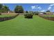Large, grassy back yard with a well-maintained lawn and wooden fencing around the property at 955 Mill Creek Ave, Canton, GA 30115