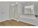 Bathroom with a separate shower, a soaking tub, and a window providing natural light at 955 Mill Creek Ave, Canton, GA 30115