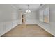 Bright dining area features modern wood floors, white trim, and a contemporary chandelier at 955 Mill Creek Ave, Canton, GA 30115
