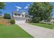 Lovely two-story home features a spacious driveway, lush lawn, and mature trees in a quiet neighborhood at 955 Mill Creek Ave, Canton, GA 30115
