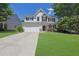 Charming two-story home with stone accents, well-manicured lawn, and an attached two-car garage at 955 Mill Creek Ave, Canton, GA 30115