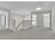 Bright upstairs hallway with neutral tones, an open staircase, and doorways to other rooms at 955 Mill Creek Ave, Canton, GA 30115