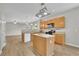 Well-lit kitchen features wood cabinets, stainless steel appliances, and a functional center island at 955 Mill Creek Ave, Canton, GA 30115