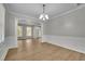 Open-concept area with wood floors, neutral paint, white trim and bright natural light at 955 Mill Creek Ave, Canton, GA 30115