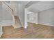 Inviting living area featuring wood floors, staircase with wood trim, and an open layout at 955 Mill Creek Ave, Canton, GA 30115