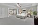 Spacious main bedroom with sitting area, ceiling fan, windows, and neutral-toned decor at 955 Mill Creek Ave, Canton, GA 30115