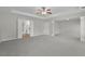 Large main bedroom with tray ceiling, ceiling fan, and adjacent bathroom and closet entries at 955 Mill Creek Ave, Canton, GA 30115