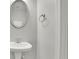 Cozy powder room features pedestal sink, decorative mirror, and neutral walls at 955 Mill Creek Ave, Canton, GA 30115