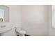 This is a powder room with a pedestal sink, a toilet, and a window with blinds at 613 Lobelia Way, Locust Grove, GA 30248