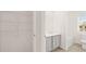This bathroom features a gray vanity, a tub, and a closet with shelving and tile flooring at 613 Lobelia Way, Locust Grove, GA 30248