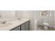 This bathroom features a double vanity with marble countertops and gray cabinets, along with tile floors at 613 Lobelia Way, Locust Grove, GA 30248