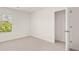 A bright neutral bedroom with a view of the exterior and access to a closet at 613 Lobelia Way, Locust Grove, GA 30248