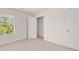 A bedroom with a window and closet is painted a bright neutral color at 613 Lobelia Way, Locust Grove, GA 30248
