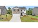 Charming two-story home featuring a brick facade, attached two-car garage, and well-manicured front lawn at 613 Lobelia Way, Locust Grove, GA 30248
