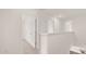A hallway with light neutral colors, white doors and trim, and carpeted floors at 613 Lobelia Way, Locust Grove, GA 30248