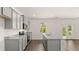 Kitchen with granite countertops, stainless steel appliances, and an island with sink, all next to French doors at 613 Lobelia Way, Locust Grove, GA 30248
