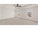 Spacious main bedroom features two windows, a ceiling fan and tray ceiling at 613 Lobelia Way, Locust Grove, GA 30248