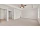 Spacious main bedroom with two windows, a ceiling fan and entrances to a closet and bathroom at 613 Lobelia Way, Locust Grove, GA 30248