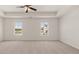 Spacious main bedroom features two windows and a ceiling fan at 613 Lobelia Way, Locust Grove, GA 30248