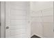 View of the pantry, featuring white wire shelving and dark wood-look flooring at 613 Lobelia Way, Locust Grove, GA 30248