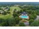 Community aerial featuring pool, golf course, landscaping, and mature trees at 6605 New Ridge Court Ct, Cumming, GA 30041