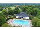 Aerial view of the community pool and clubhouse surrounded by lush trees at 6605 New Ridge Court Ct, Cumming, GA 30041
