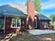 Brick home exterior featuring a patio and well-maintained landscaping at 6605 New Ridge Court Ct, Cumming, GA 30041