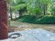Brick home exterior, showcasing the patio and a lush, green landscape at 6605 New Ridge Court Ct, Cumming, GA 30041