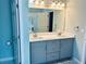 Bathroom vanity featuring double sinks, a large mirror and modern lighting at 6605 New Ridge Court Ct, Cumming, GA 30041