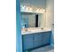 Bathroom vanity featuring double sinks, a large mirror and modern lighting at 6605 New Ridge Court Ct, Cumming, GA 30041