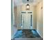 Inviting entryway features a stylish light fixture and tiled floor at 6605 New Ridge Court Ct, Cumming, GA 30041