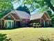 Attractive brick home features manicured landscaping and a well-maintained lawn at 6605 New Ridge Court Ct, Cumming, GA 30041
