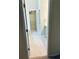 Hallway view with tile flooring leading to closet and bathroom at 6605 New Ridge Court Ct, Cumming, GA 30041