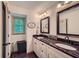 Bathroom with granite countertop, dual sinks, and modern fixtures at 1580 Smyrna Sw Rd, Conyers, GA 30094
