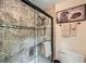 Bathroom featuring a tiled shower with glass door and decorative accents at 1580 Smyrna Sw Rd, Conyers, GA 30094
