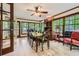 Bright dining room features wood floors, a ceiling fan, and large windows with picturesque views at 1580 Smyrna Sw Rd, Conyers, GA 30094