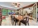 Bright dining room with wood table, ceiling fan, and large windows overlooking the lush landscape at 1580 Smyrna Sw Rd, Conyers, GA 30094