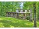 Charming two-story brick home nestled in a wooded setting with a beautifully landscaped front yard at 1580 Smyrna Sw Rd, Conyers, GA 30094
