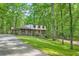 Beautifully landscaped home with a long driveway and mature trees, exuding charm and tranquility at 1580 Smyrna Sw Rd, Conyers, GA 30094