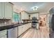Well-lit kitchen features stainless steel appliances, granite countertops, and tile backsplash at 1580 Smyrna Sw Rd, Conyers, GA 30094