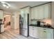 Kitchen with stainless steel refrigerator, white cabinets, granite counters, and modern flooring at 1580 Smyrna Sw Rd, Conyers, GA 30094