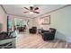 Open-concept living room with ceiling fan, hardwood floors, and comfortable seating at 1580 Smyrna Sw Rd, Conyers, GA 30094