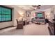 Spacious main bedroom retreat with comfortable seating, plush bedding, and large windows offering scenic views at 1580 Smyrna Sw Rd, Conyers, GA 30094