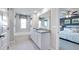 Modern bathroom with double sink vanity, separate tub, and access to main bedroom at 174 Aster Avenue, Locust Grove, GA 30248