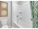 Bathroom featuring a bright white tub and a modern shower at 174 Aster Avenue, Locust Grove, GA 30248