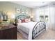 Charming bedroom featuring a metal bed frame and a window offering natural light at 174 Aster Avenue, Locust Grove, GA 30248