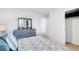 Serene bedroom with a gray dresser, an open closet, and neutral tones at 174 Aster Avenue, Locust Grove, GA 30248