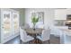 Cozy dining area features a chandelier, wood table, and access to the kitchen at 174 Aster Avenue, Locust Grove, GA 30248
